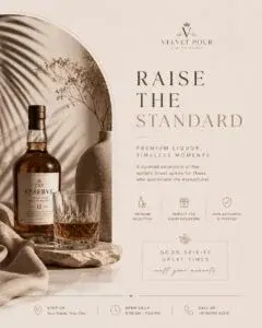 Elegant promotional ad poster for a luxury liquor brand with a bottle, glass on the rocks, and text reading "RAISE THE STANDARD."
